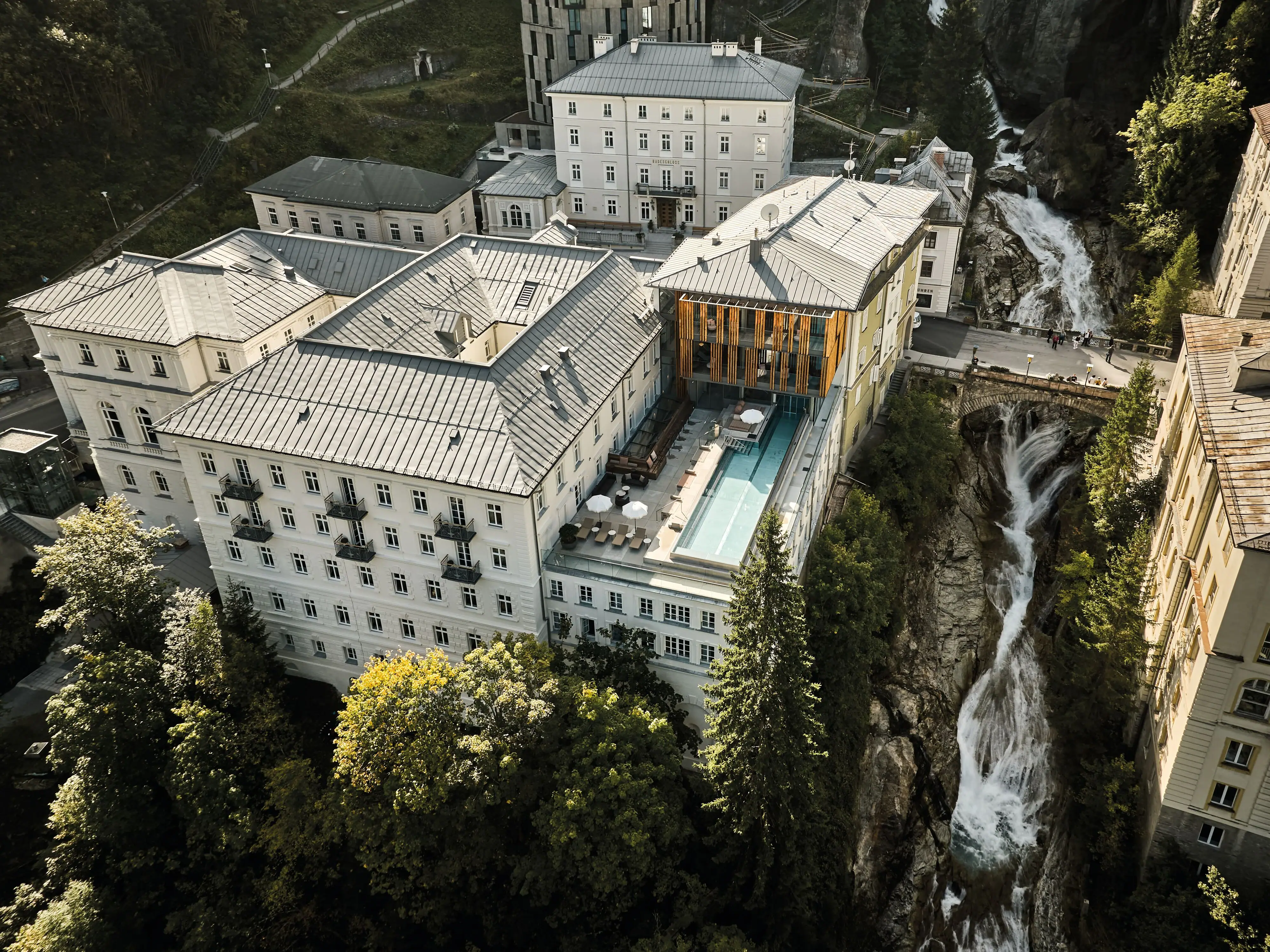 A-ROSA Bad Gastein from above A building with a rooftop swimming pool.