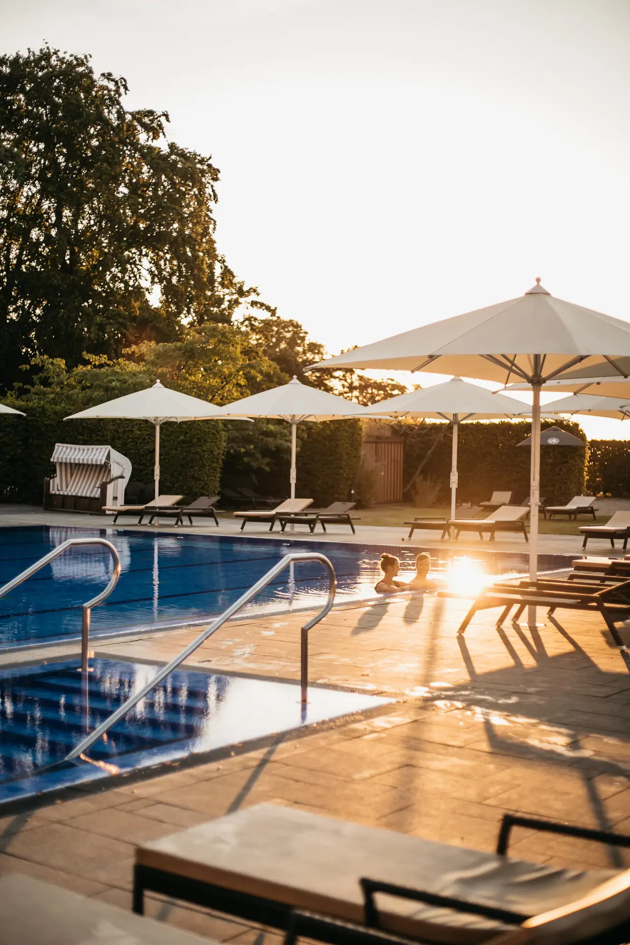 Outdoor swimming pool An outdoor swimming pool with parasols and sun loungers.