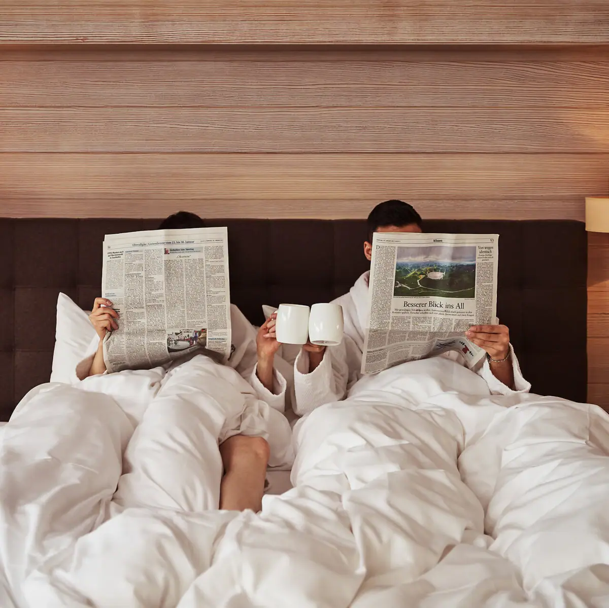 A man and woman reading in bed.