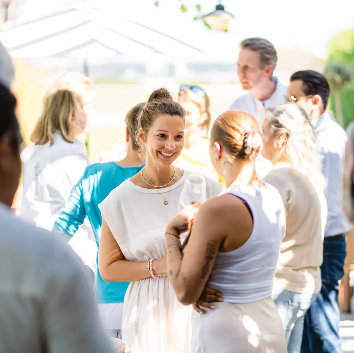 A group of people at a wedding, featuring a bride in a wedding dress.